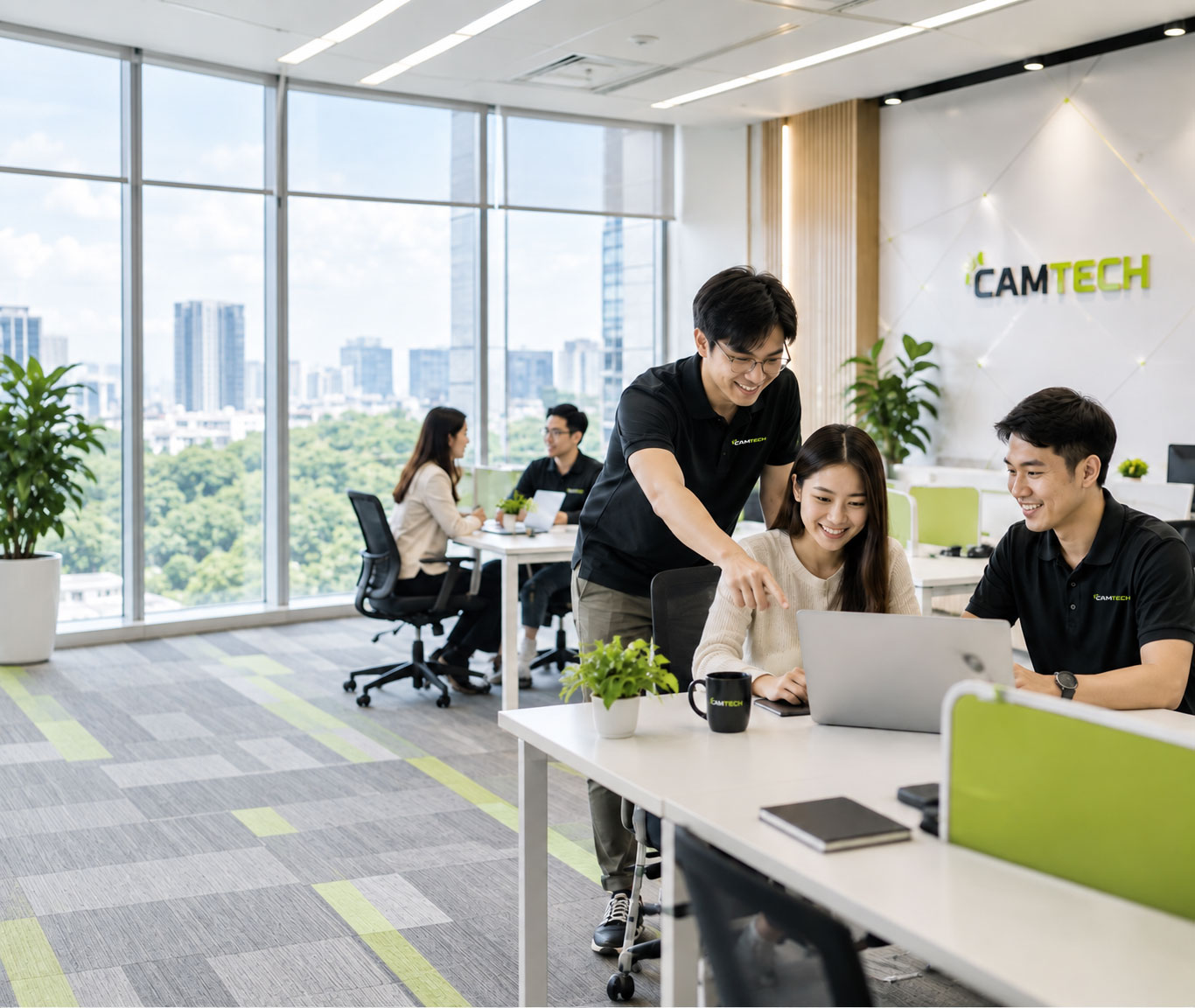 Camtech staff working together at a laptop in the company office